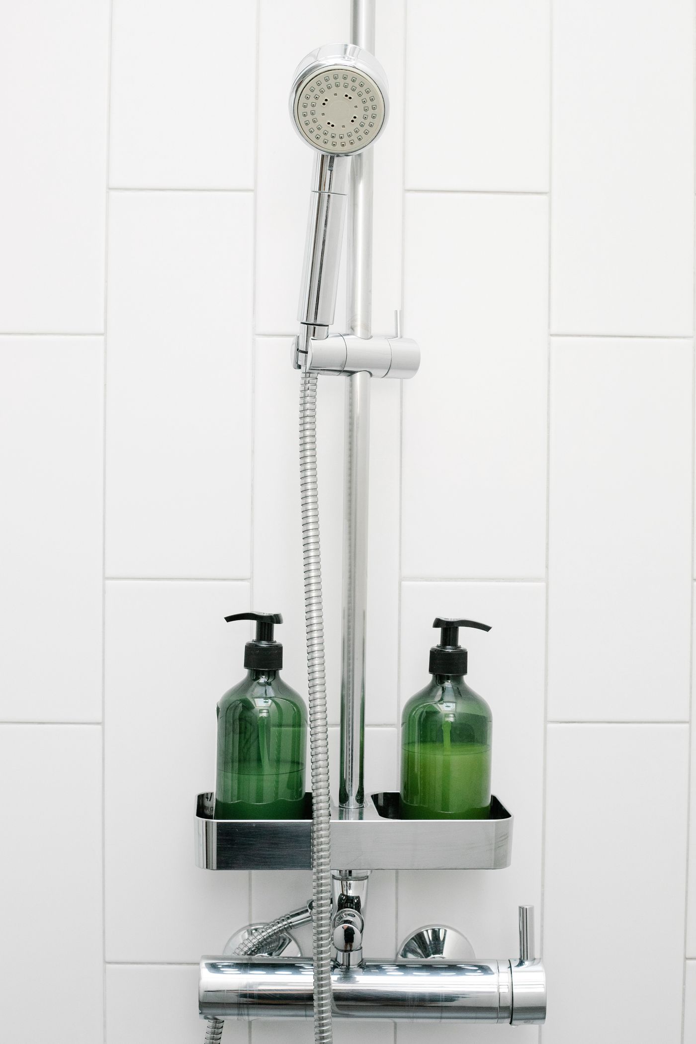 Bottles of toiletries on bathroom shelf