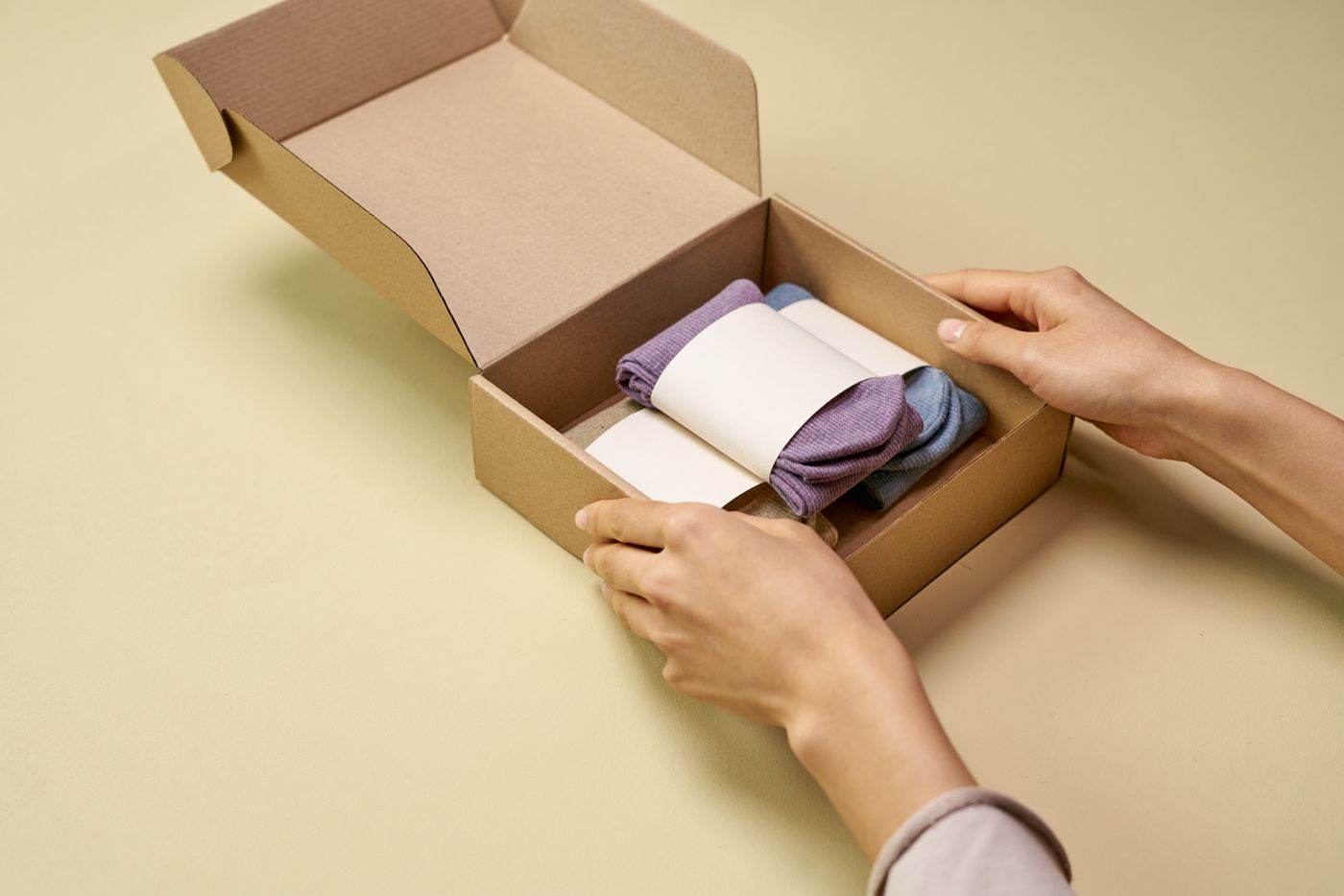 Folded socks beside a cardboard box