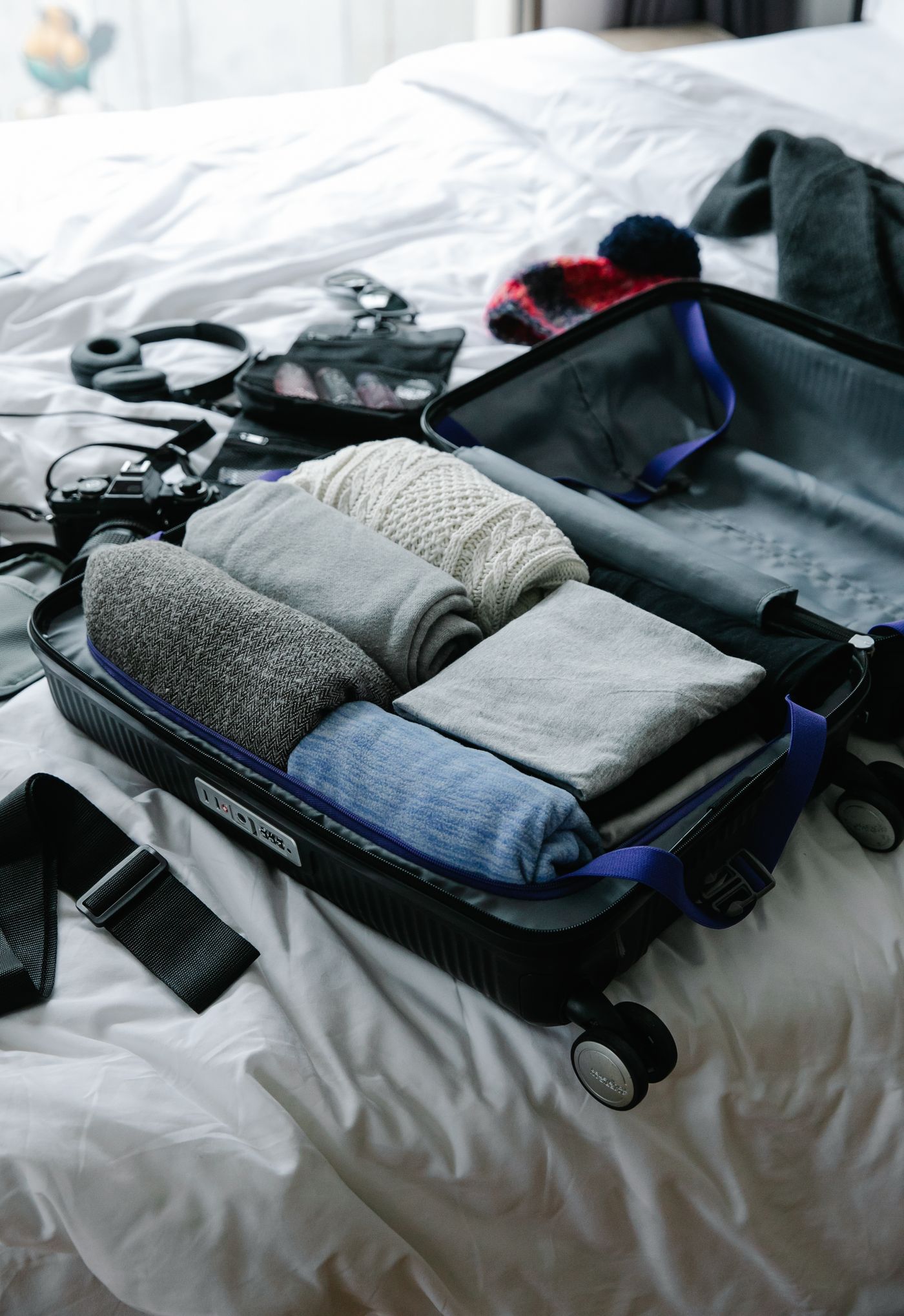 Open suitcase with folded clothing